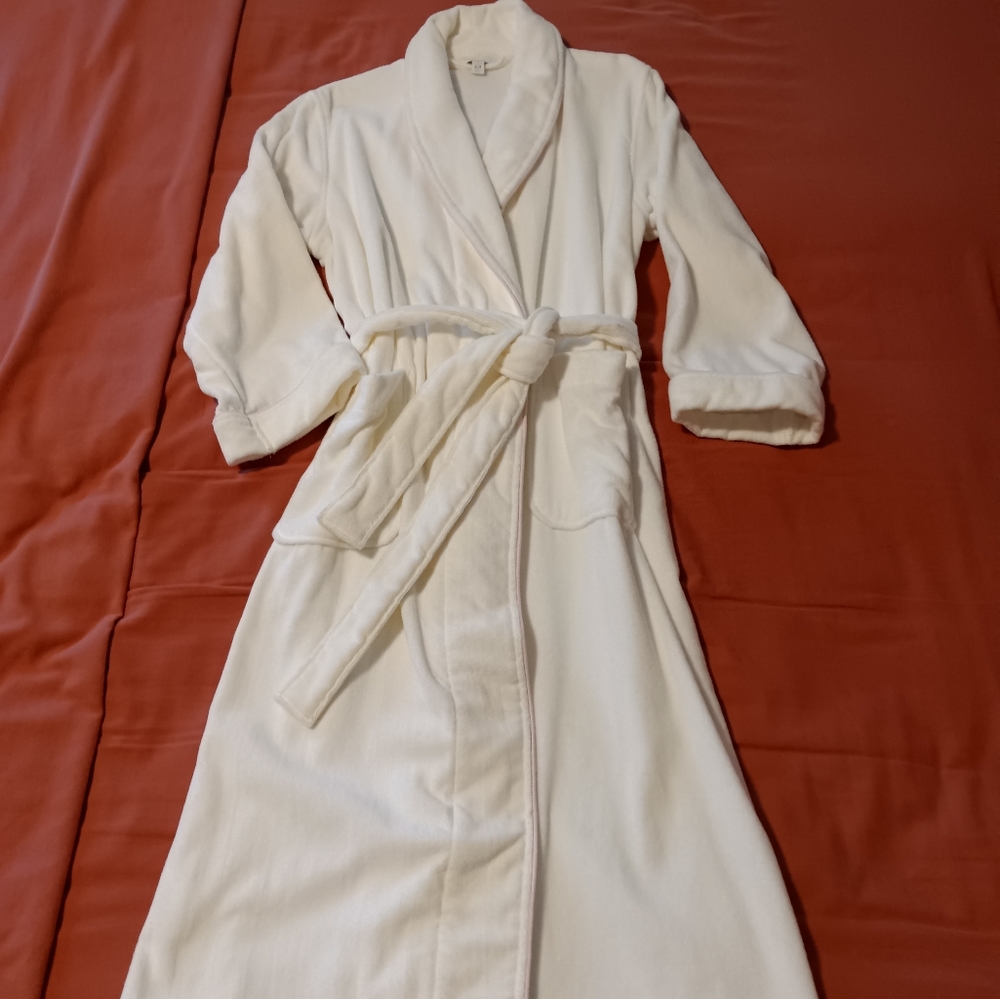White terry robe with pink trim.